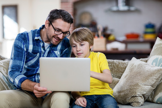 Man and boy looking at computer screen