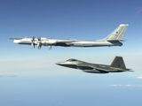 In this image taken Tuesday, June 16, 2020, and released by the North American Aerospace Defense Command, one of two Russian Tu-95 bombers is escorted off the coast of Alaska by a U.S. F-22 Raptor fighter. NORAD planes escorted the two Russian Tu-142s during their four-hour flight. Military officials say the Russian jets never left international airspace but did come within 50 miles of Alaskas northern coast at one point. (North American Aerospace Defense Command via AP)