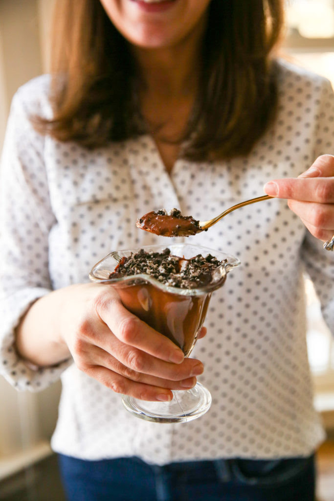 Jenny holding Cookies and Cream Chocolate Pudding cups with gluten-free Oreos on top