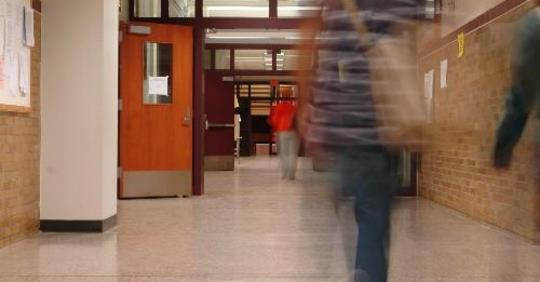 stduents walking in school hallway