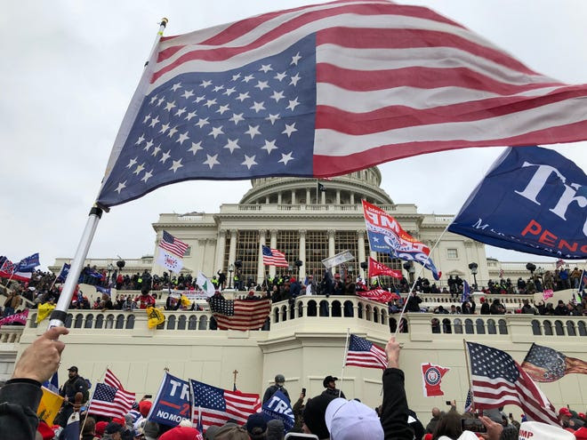 Jan. 6, 2021: Rioters stand on the U.S. Capitol building during an insurrection to protest the official election of President-elect Joe Biden in Washington D.C.