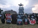 Protesters with shields and gas masks wait for police action as they surround the statue of Confederate Gen. Robert E. Lee on Monument Avenue, Tuesday, June 23, 2020, in Richmond, Va. The state has ordered the area around the statue closed from sunset to sunrise. (AP Photo/Steve Helber) ** FILE **