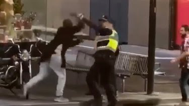 Police confront Hassan Khalif Shire Ali in Bourke Street last year.