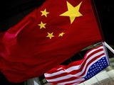 In this Nov. 7, 2012, photo, U.S. and Chinese national flags are hung outside a hotel during the U.S. Presidential election event, organized by the U.S. Embassy in Beijing. (AP Photo/Andy Wong) ** FILE **