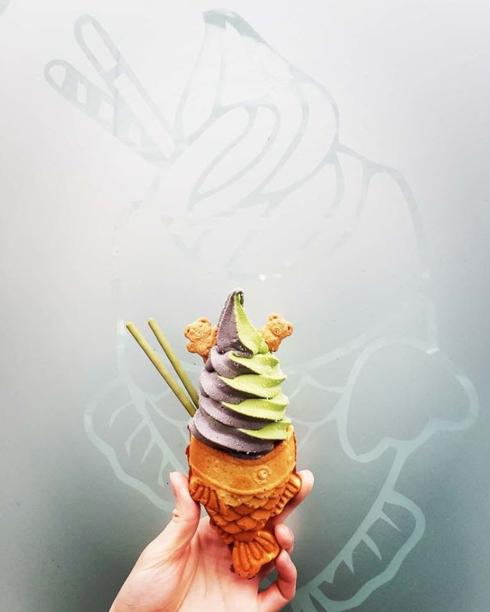 Uzu Taiyaki fish shaped ice cream cone with black and green soft serve ice cream