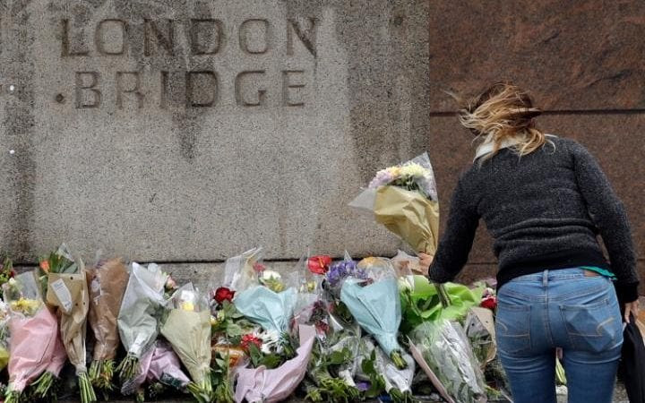 A woman places flowers on London Bridge after the latest terror atrocity to hit Britain