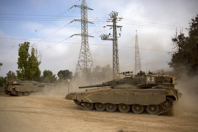 Israeli tanks move near the Israel and Gaza border Thursday, July 24, 2014. Israeli tanks and warplanes bombarded the Gaza Strip on Thursday, as Hamas milita...