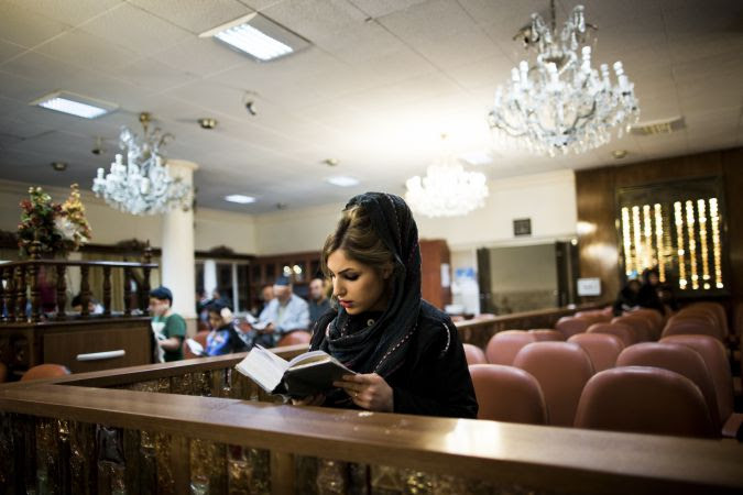 A young Jewish Iranian woman prays at a synagogue in Tehran.