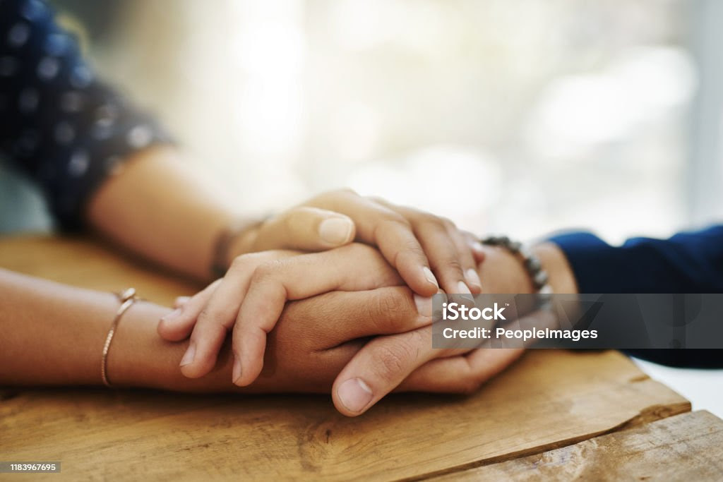 Be the person who helps the next Closeup shot of two unrecognizable people holding hands in comfort Support Stock Photo