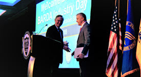 Dr. Kadlec and Dr. Bright shaking hands on stage