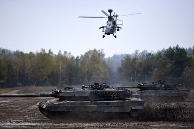 A Leopard tank and Tiger helicopter of the German Armed Forces participating in military exercises in October near Bergen, Germany. 