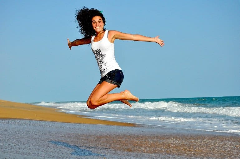 This shows a happy woman at a beach