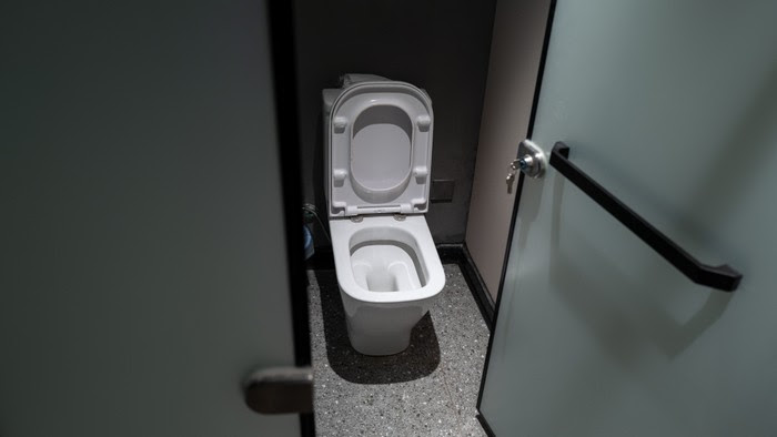 A photo of a toilet with the lid up