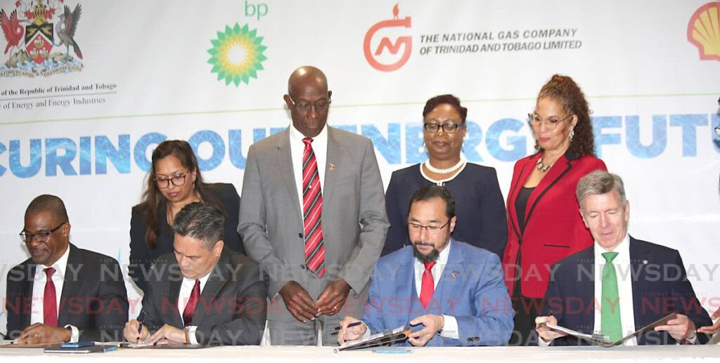 Prime Minister Dr Keith Rowley and government officials witness the signing of the heads of agreement of Atlantic LNG shareholders, from left, Shell TT country chairman Eugene Okpere, NGC president Mark Loquan, Energy Minister Stuart Young and bpTT president David Campbell at Hilton Trinidad, Port of Spain on Tuesday. File photo/Sureash Cholai