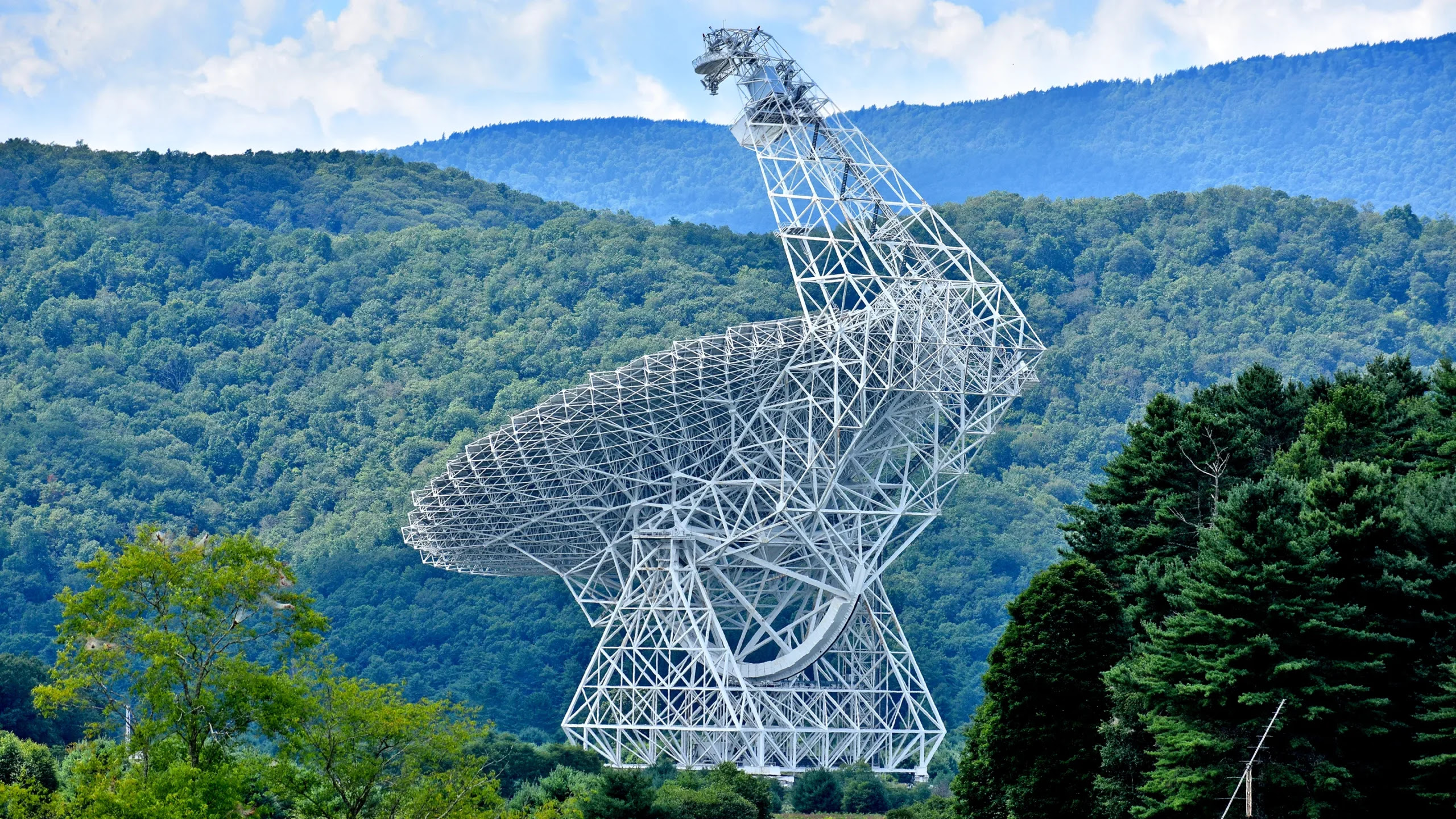 The Green Bank Telescope showing its large white telescope dish.