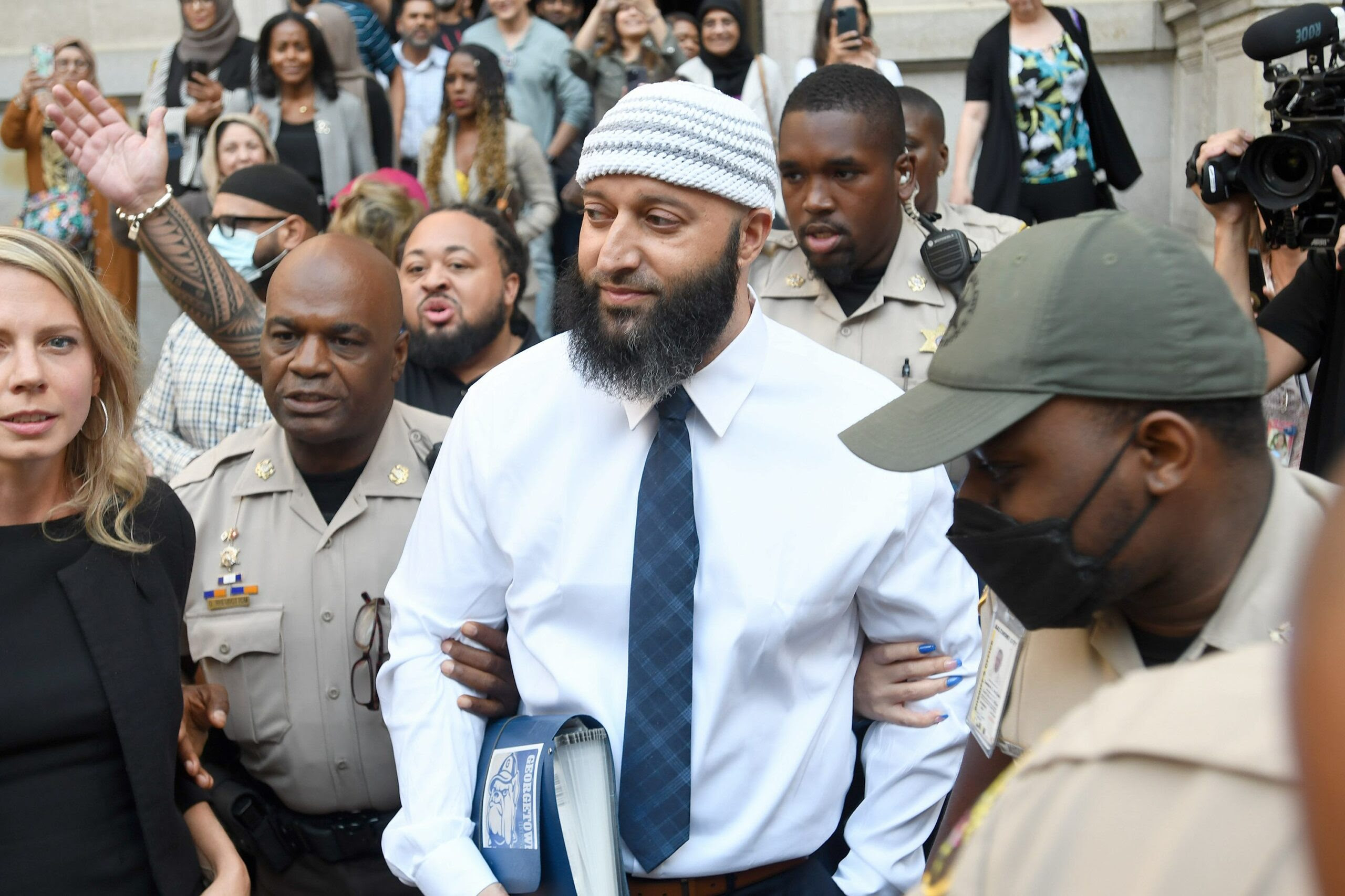 Adnan Syed, center, whose case gained notoriety from the hit podcast “Serial,” leaves a courthouse after a judge vacated his 2000 murder conviction Monday, Sept. 19, 2022 in Baltimore. (Image: Steve Ruark/AP Images for The Innocence Project)