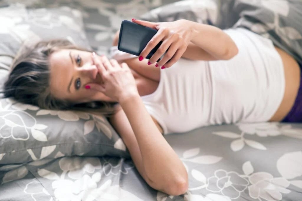 A woman looking at her phone wondering if blue waffle is real.