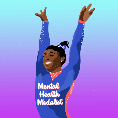 Image of Simone Biles saluting. Words on her leotard read "mental health medalist"