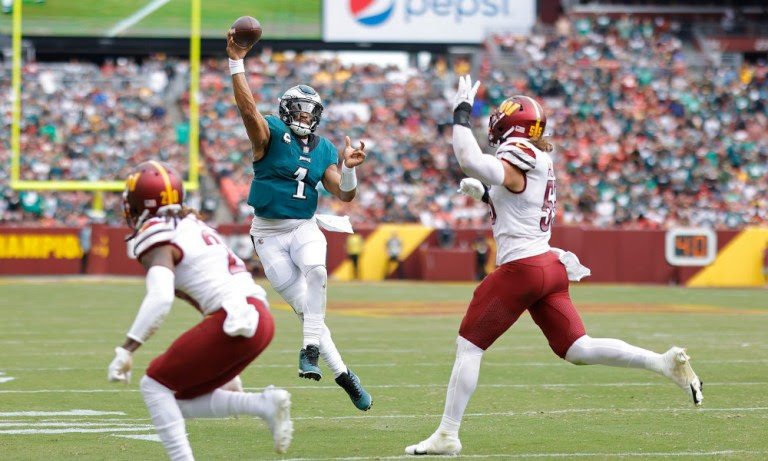 Jalen Hurts (#1) throws a pass for Eagles versus Commanders