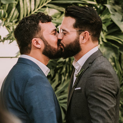 gay couple kisses at their wedding