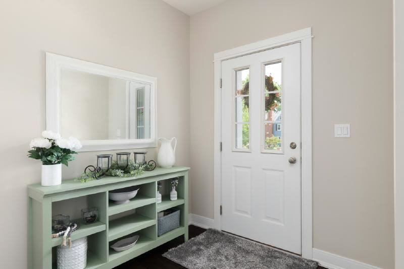 A white door with a green shelf Description automatically generated