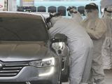 Medical staff wearing protective suits take samples from a driver with symptoms of the coronavirus at a &amp;quot;drive-through&amp;quot; virus test facility in Goyang, South Korea, Sunday, March 1, 2020. The coronavirus has claimed its first victim in the United States as the number of cases shot up in Iran, Italy and South Korea and the spreading outbreak shook the global economy. (AP Photo/Ahn Young-joon)