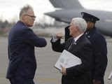 Vice President Mike Pence greets Washington Gov. Jay Inslee, left, as Pence arrives, Thursday, March 5, 2020 at Joint Base Lewis-McChord in Washington state. Officials are avoiding handshakes due to the COVID-19 coronavirus. (AP Photo/Ted S. Warren)