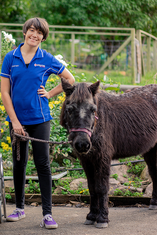 Compass participant, Courtney standing next to Valerie the pony