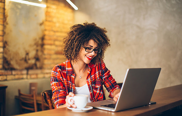 A woman using her laptop at a cafe.