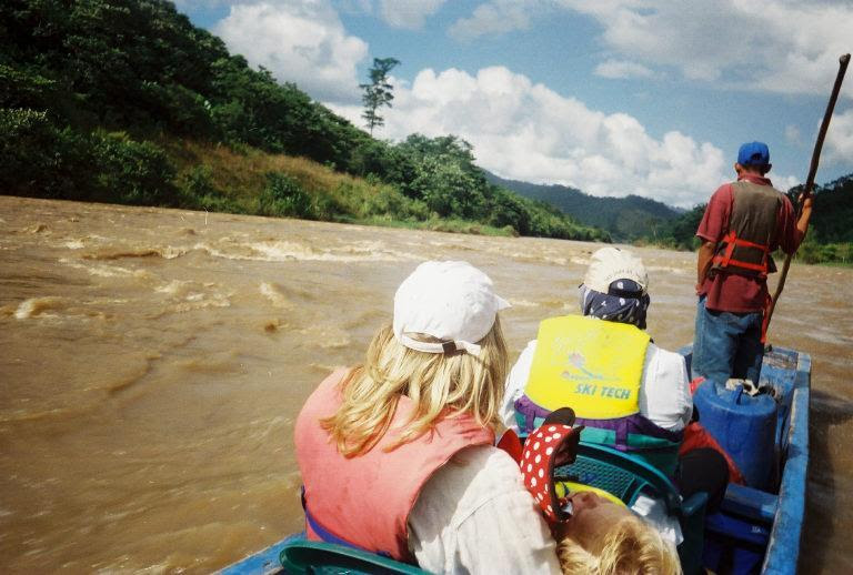 couple with sleeping baby in the rapids