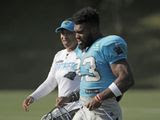 Carolina Panthers coaching intern Jennifer King, left, talks with Elijah Holyfield (33) during practice at the NFL football team&#39;s training camp in Spartanburg, S.C., Monday, July 29, 2019. (AP Photo/Chuck Burton) **FILE** 