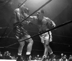 Joe Louis winces from a right to the head delivered by Rocky Marciano during the fifth round of their non-title bout at Madison Square Garden in Oct. 1951. Marciano won in the eighth round. (AP...