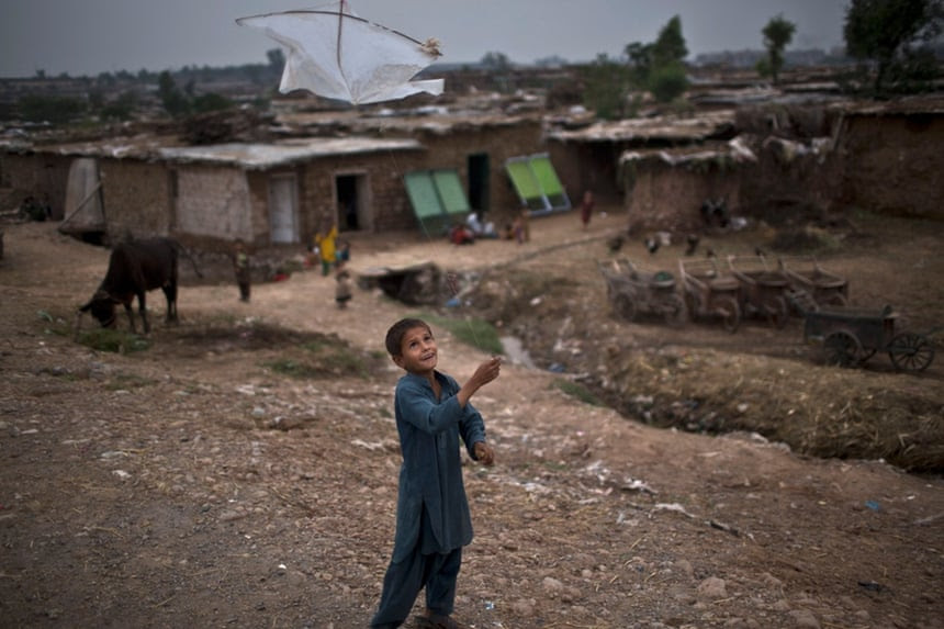 An Afghan refugee child plays with a kite