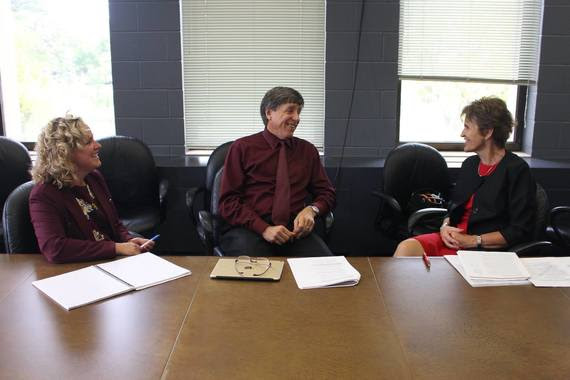 State Superintendent Jillian Balow, Community College Commission Executive Director Jim Rose, and University of Wyoming President Laurie Nichols sit at a conference table having a discussion.