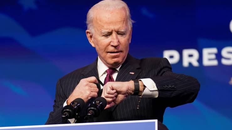 Joe Biden looking at his watch