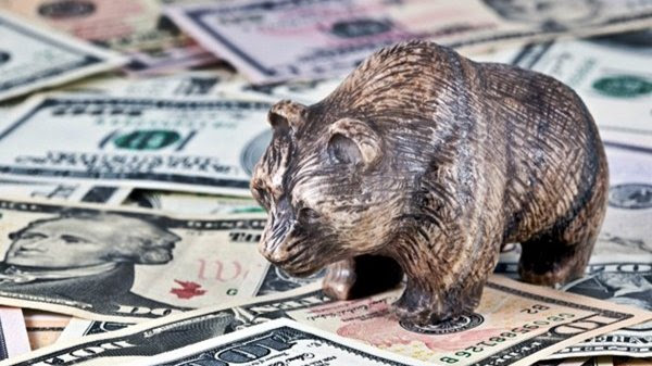 A bear figuring standing on top of a pile of currency