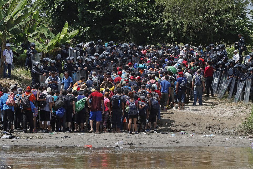 The second migrant caravan, including members believed to be carrying bombs and guns, crossed into Mexico on Monday despite a huge police presence. Cops are seen allowing some of the migrants on the banks of the Suchiate River after the arduous crossing, but they were stopped from moving any further