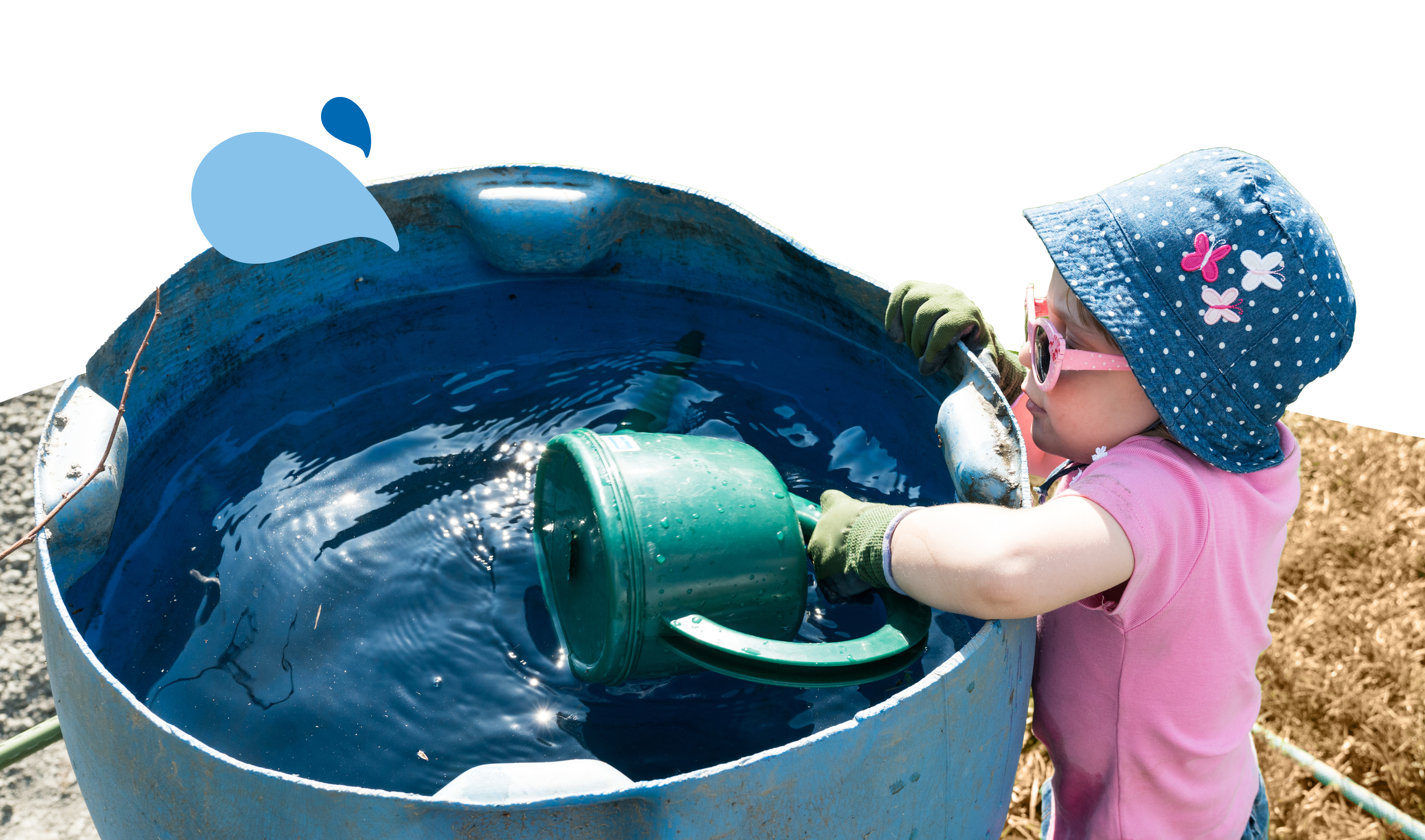 A young girl refills a watering can from a water butt