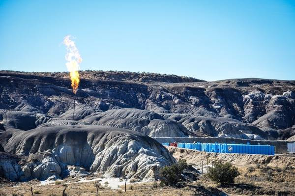 An oil well flares off excess methane in the desert east of Farmington, New Mexico. (Courtesy of Michael Eisenfeld)