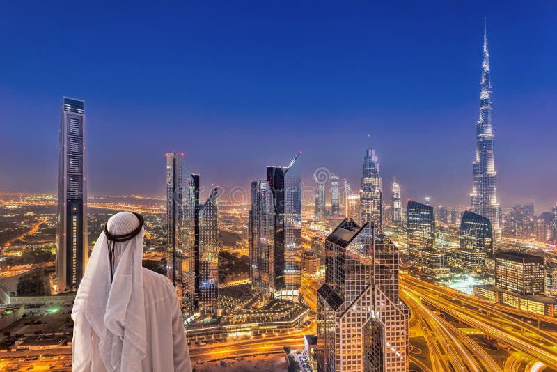 Arabian Man Watching Night Cityscape Of Dubai With Modern Futuristic  Architecture In United Arab Emirates Stock Photo - Image of east, hotel:  121393770