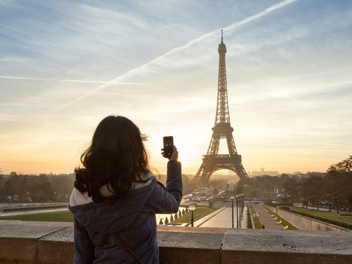 Woman photographing the Eiffel Tower