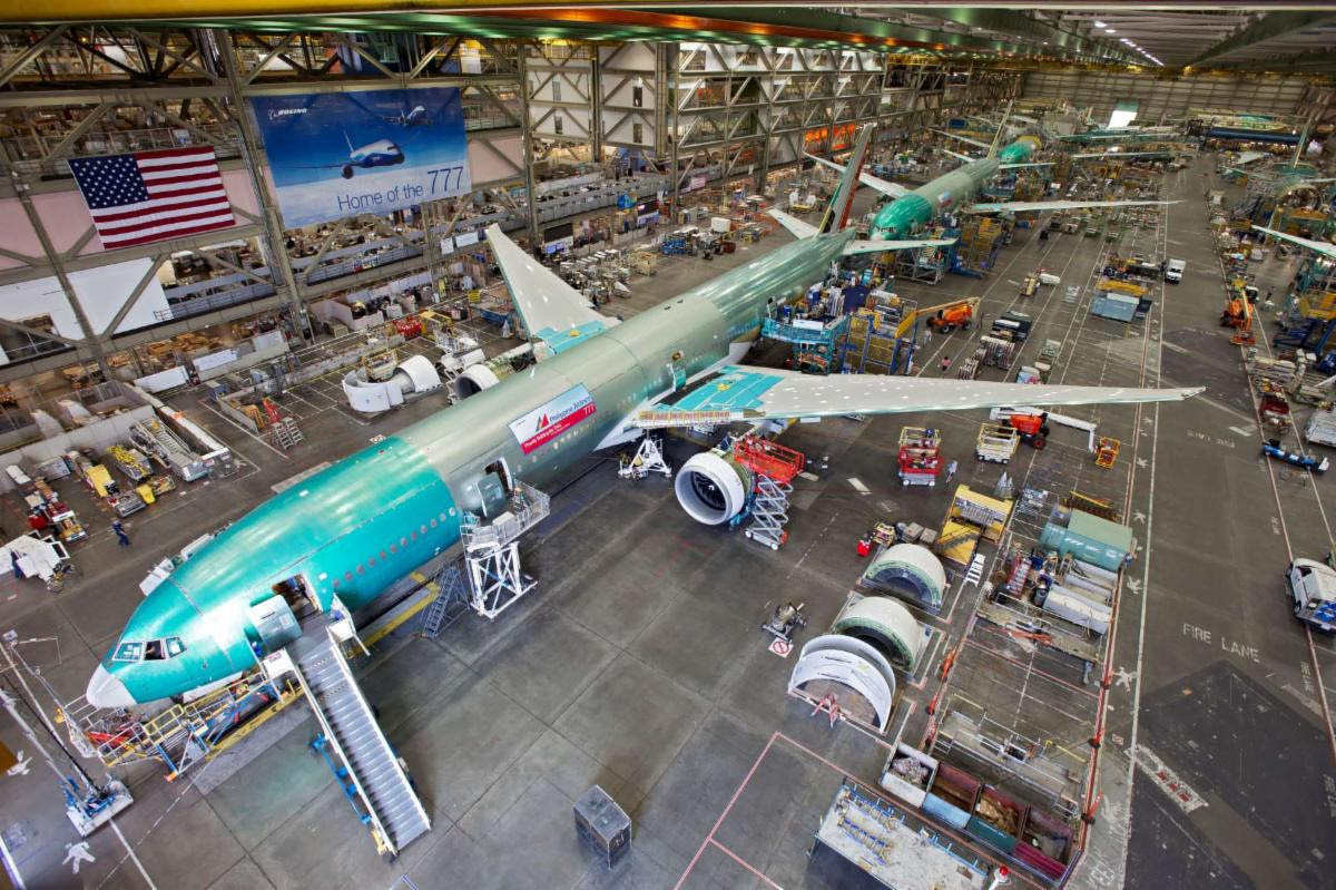 A photo of a plane being built in a factory. 