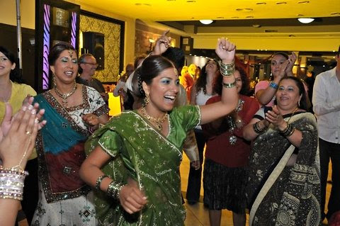 Yamit Talker-Shefer in a green sari dances with family and friends during her Indian wedding ceremony in Rehovot, Israel, 2009.