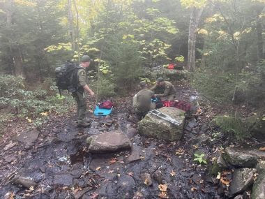 Rangers in woods during rescue