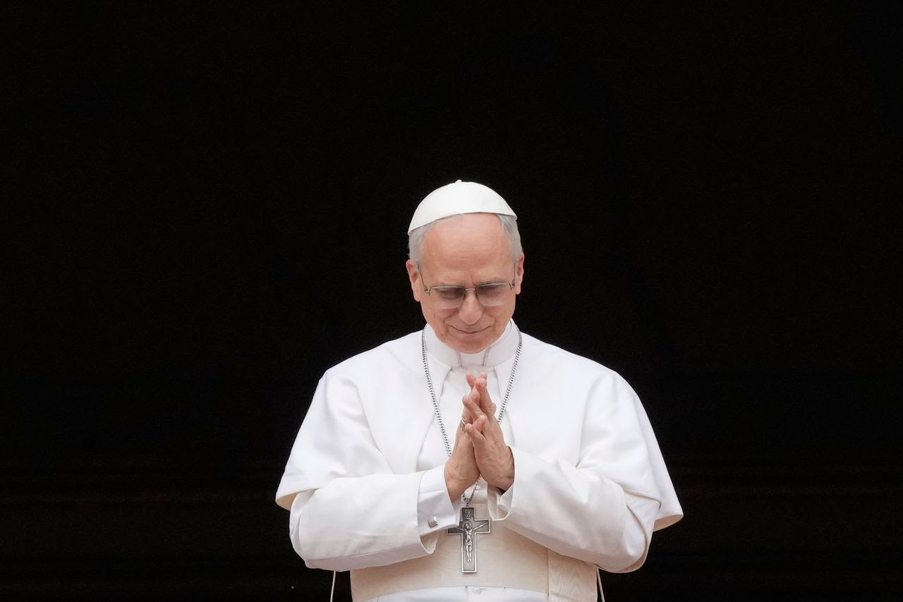 Pope Leo XIV appears at the central balcony of St. Peter's Basilica at the Vatican on May 11 for his first Sunday blessing following his election. (Gregorio Borgia/AP)