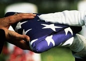 Survivors' Pension; folded American flag handed to survivor