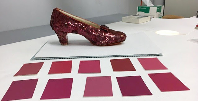 One of the Ruby Slippers seen with a range of ruby-colored paint chips as a quick color match