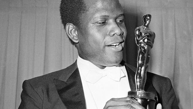 Actor Sidney Poitier is photographed with his Oscar statuette at the 36th Annual Academy Awards in Santa Monica, Calif., on April 13, 1964. He won Best Actor for his role in "Lilies of the Field."