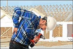 The figure above is a photograph showing a construction worker experiencing back pain.