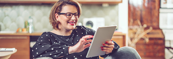 woman accessing services online via her tablet